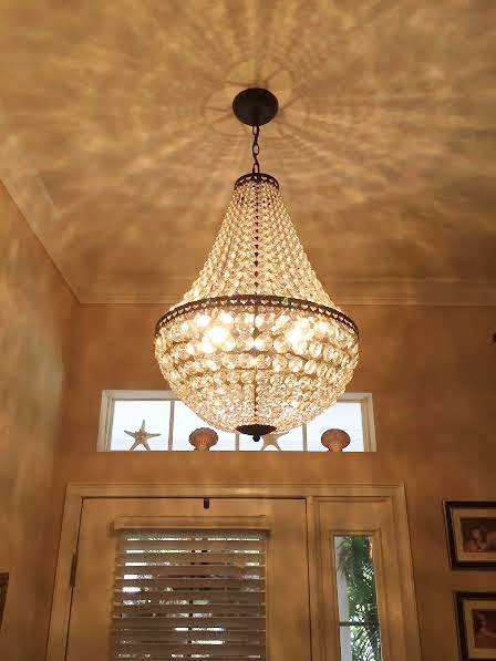 A chandelier hanging over a doorway in a home